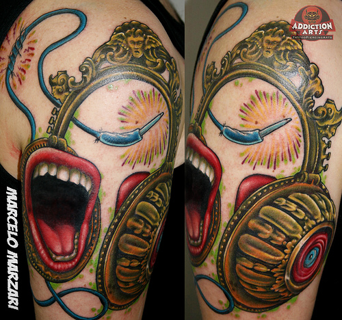 We came across this interesting tattoo of headphones with large mouths on 